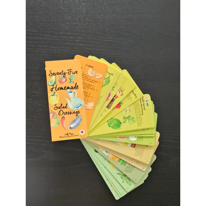 A fanned-out set of colorful recipe cards titled "Seventy-Five Homemade Salad Dressings" on a dark textured background.