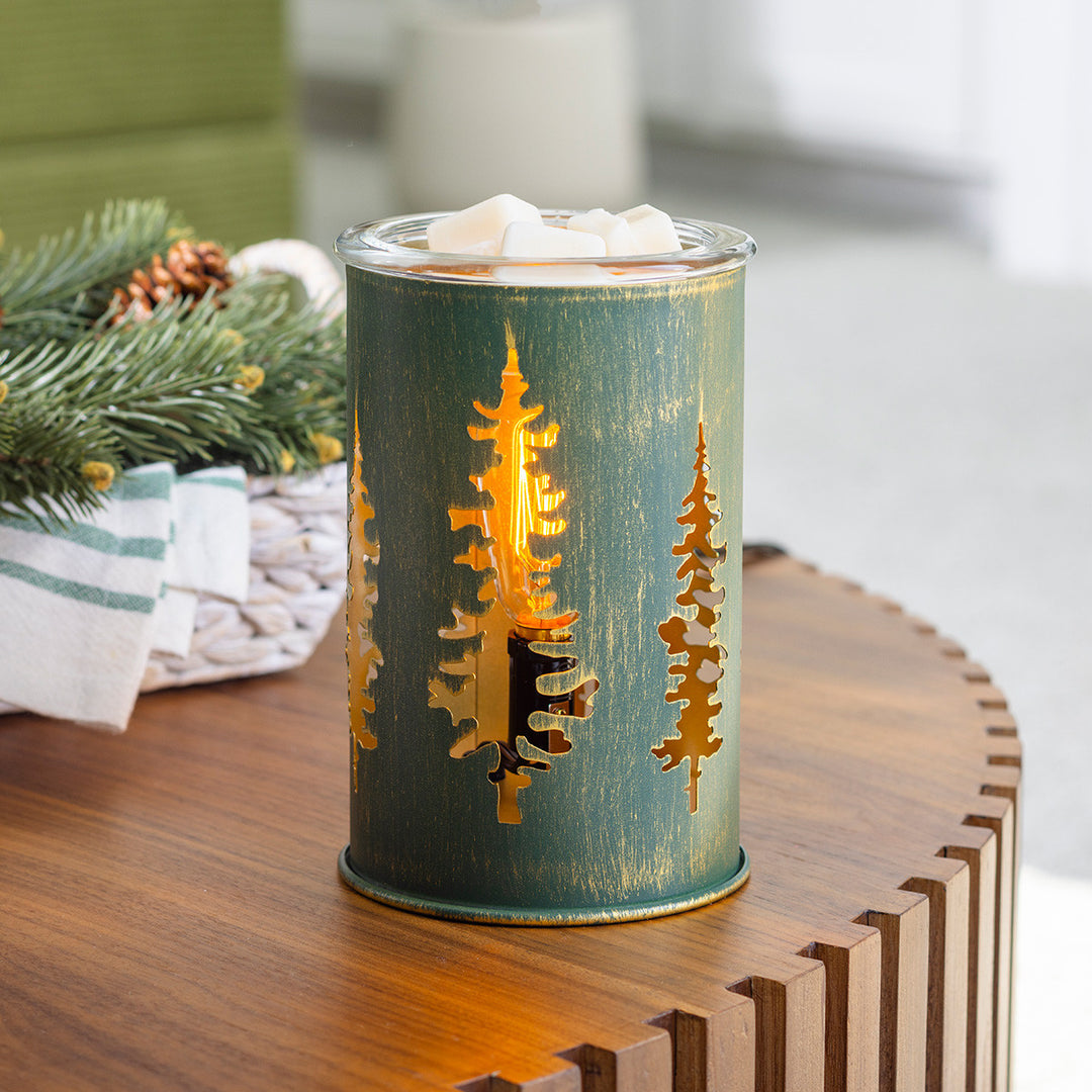 Decorative candle holder with tree design on a wooden surface
