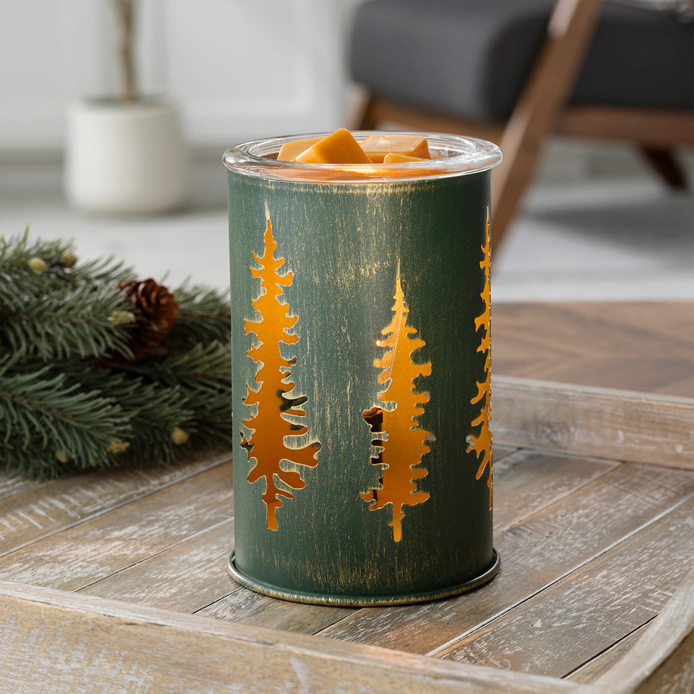 Decorative candle holder with tree design on a wooden surface