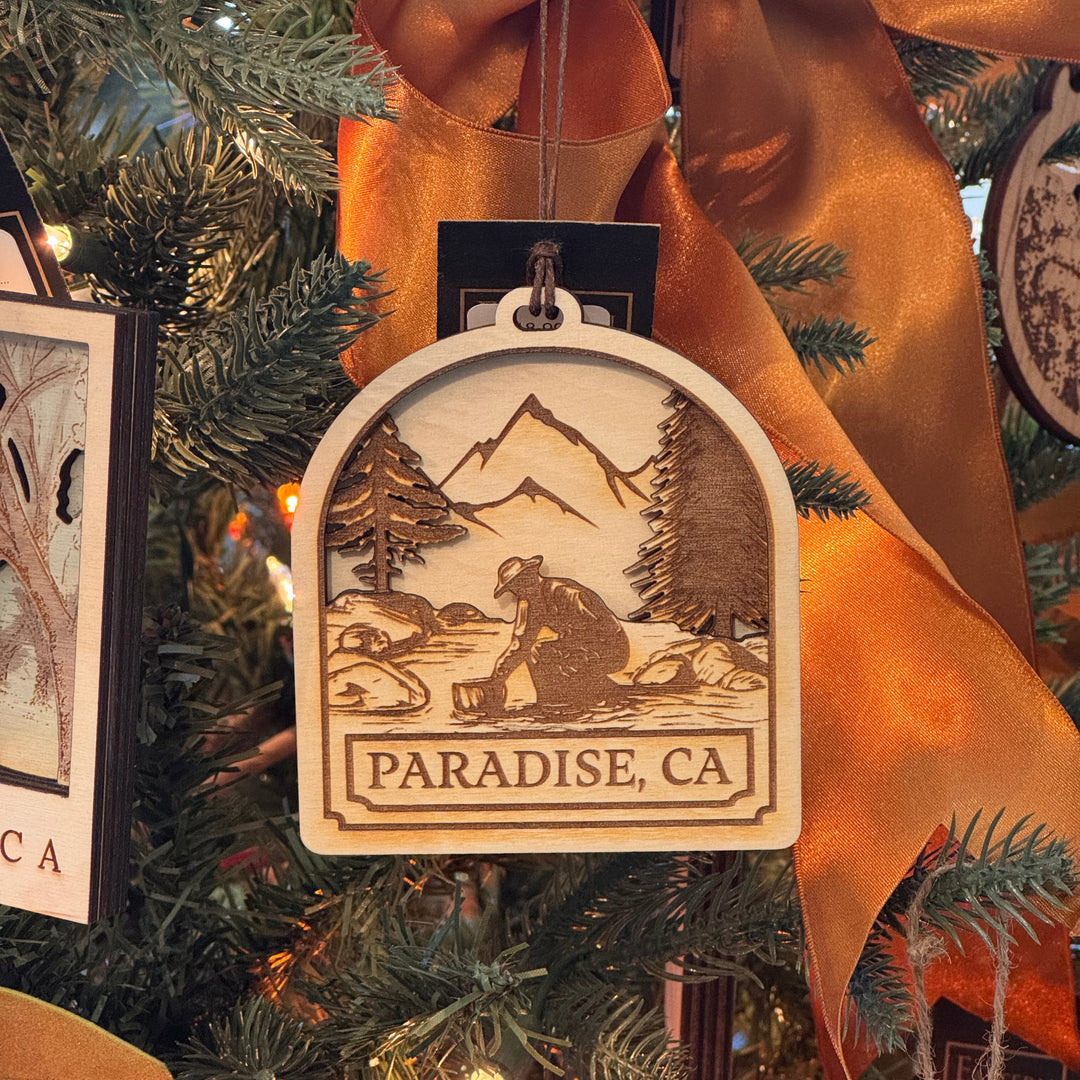 Decorative ornament with 'Paradise, CA' text on a Christmas tree.