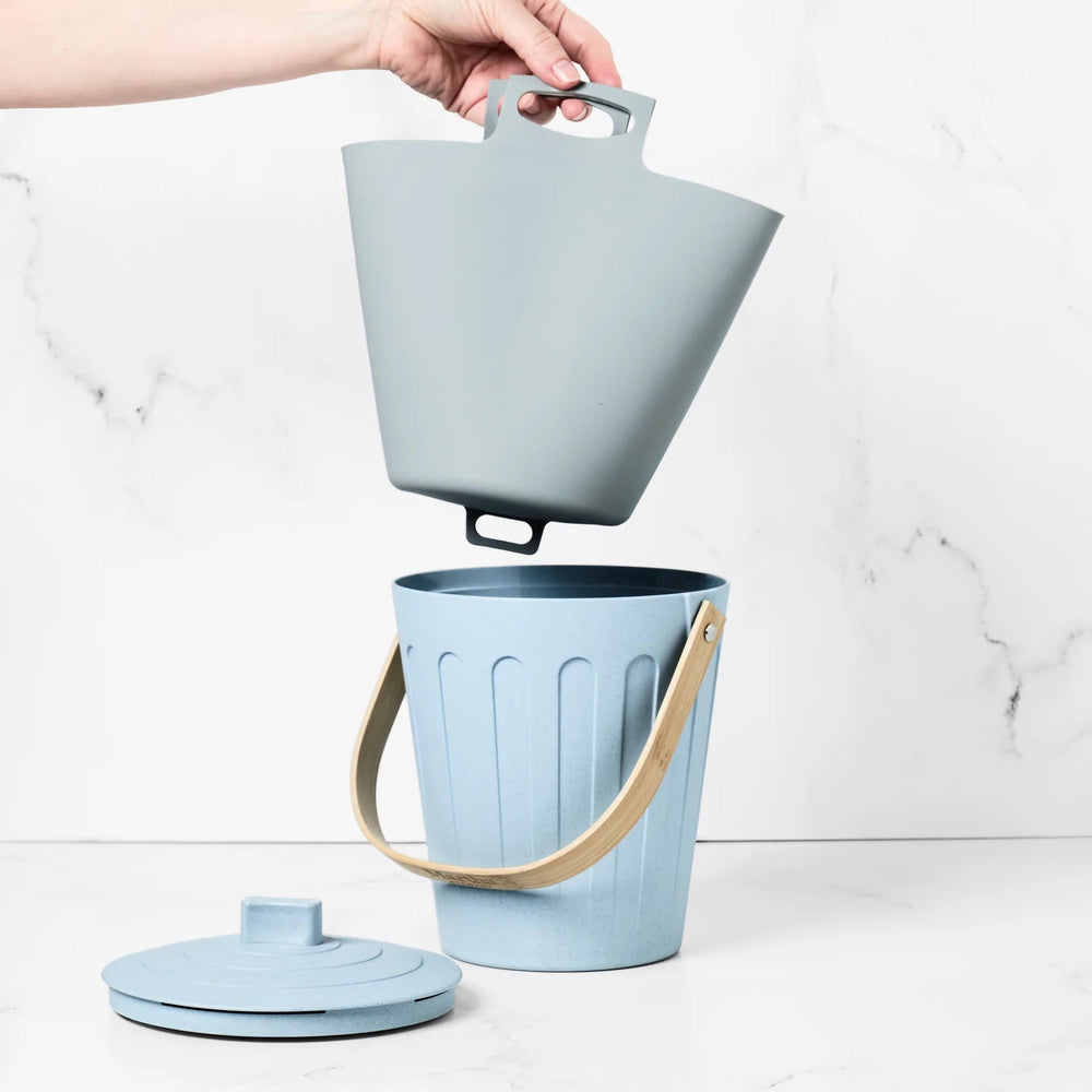 Light blue trash bin with a lid and handle on a white background