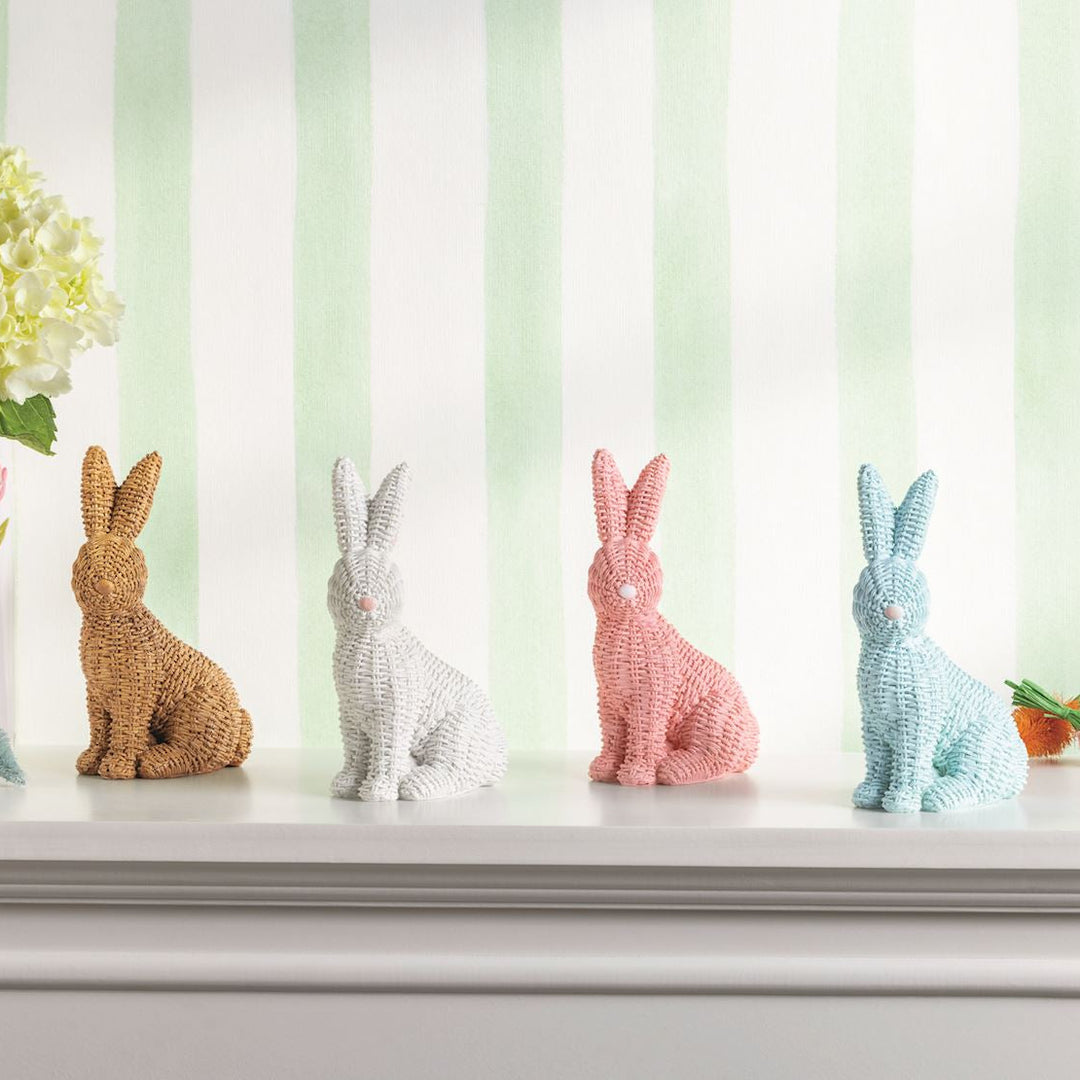 Decorative bunny figurines on a shelf with a striped background