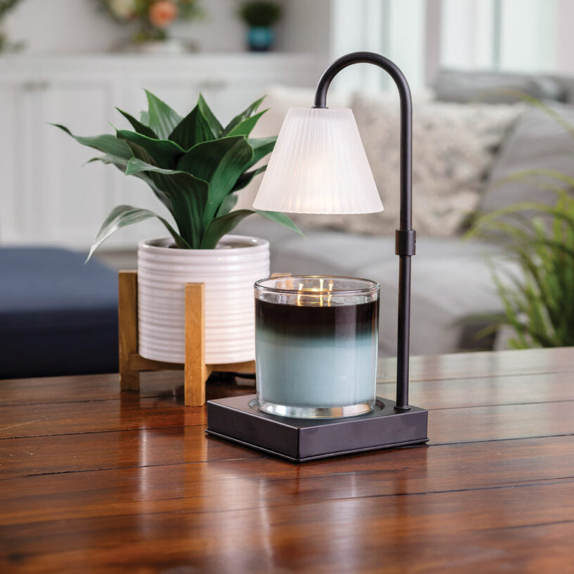 Candle holder with a candle on a wooden table in a living room setting