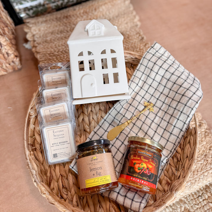 Basket with candles, a lantern, and jars on a textured surface