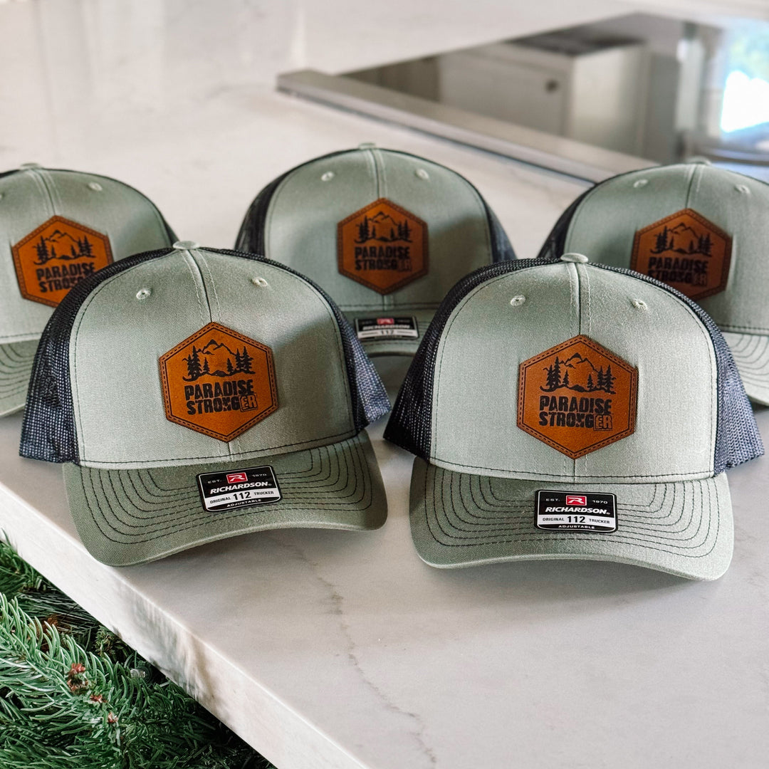 Green and blue caps with a logo on a marble surface