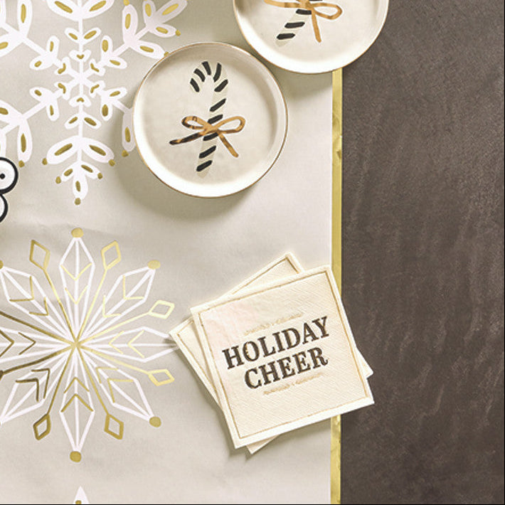 Decorative Christmas plates with snowflakes and 'Merry Christmas' text on a gray background.