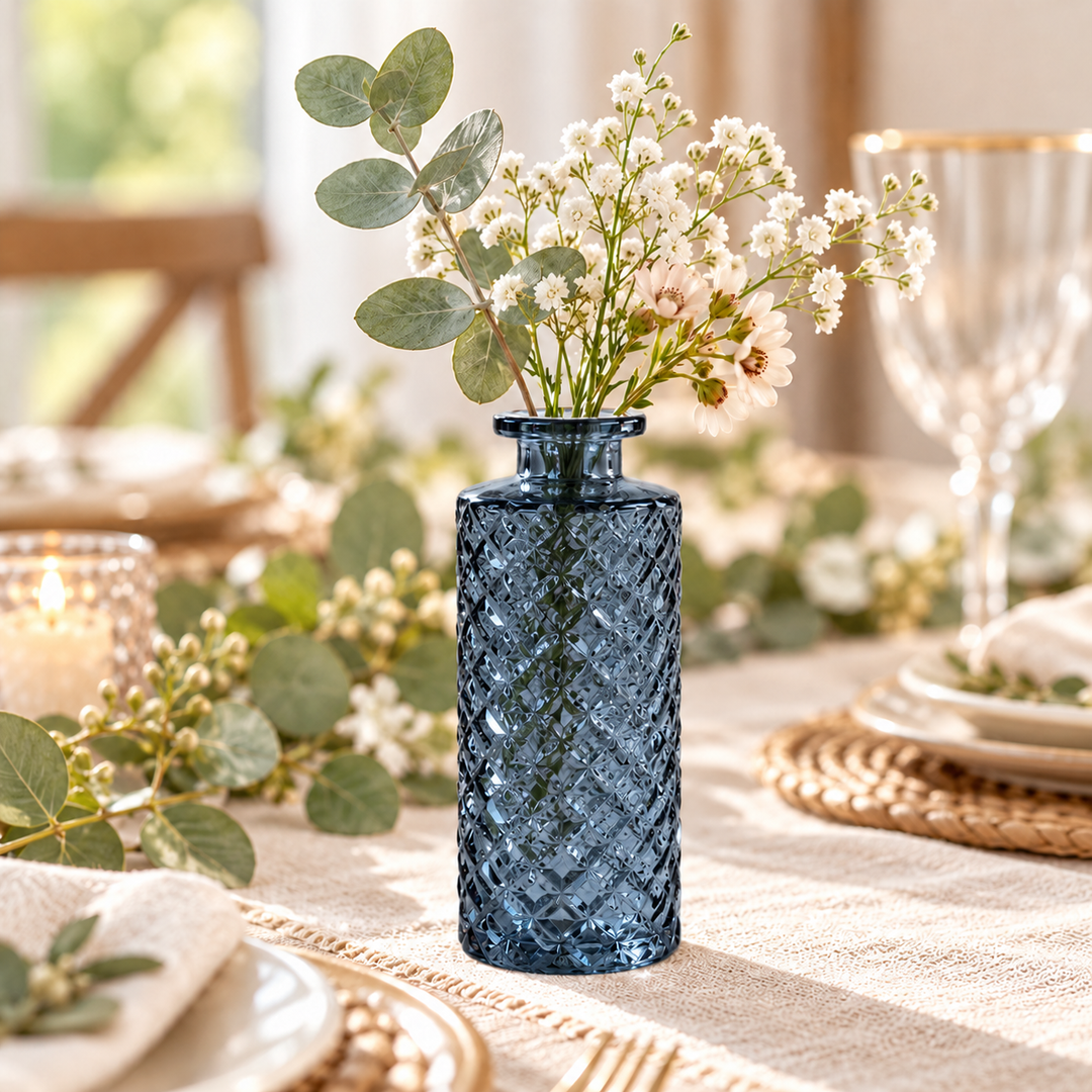 Slate Blue textured glass bud vase with eucalyptus and delicate white flowers styled on a warm neutral tablescape.