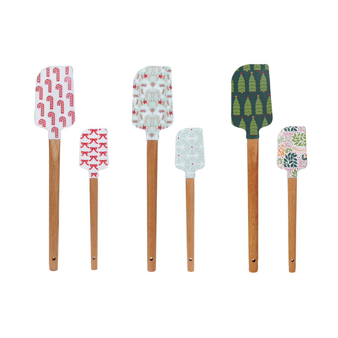 Set of six spatulas with patterned handles on a white background