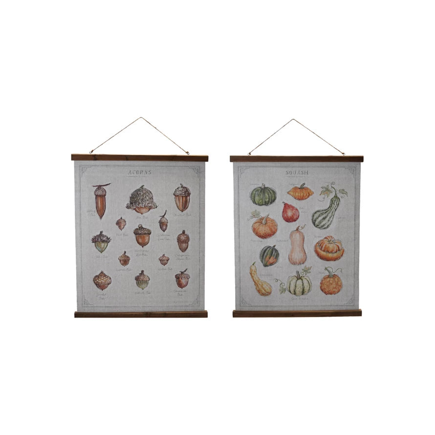 Two wall hangings with acorn and pumpkin illustrations on a white background