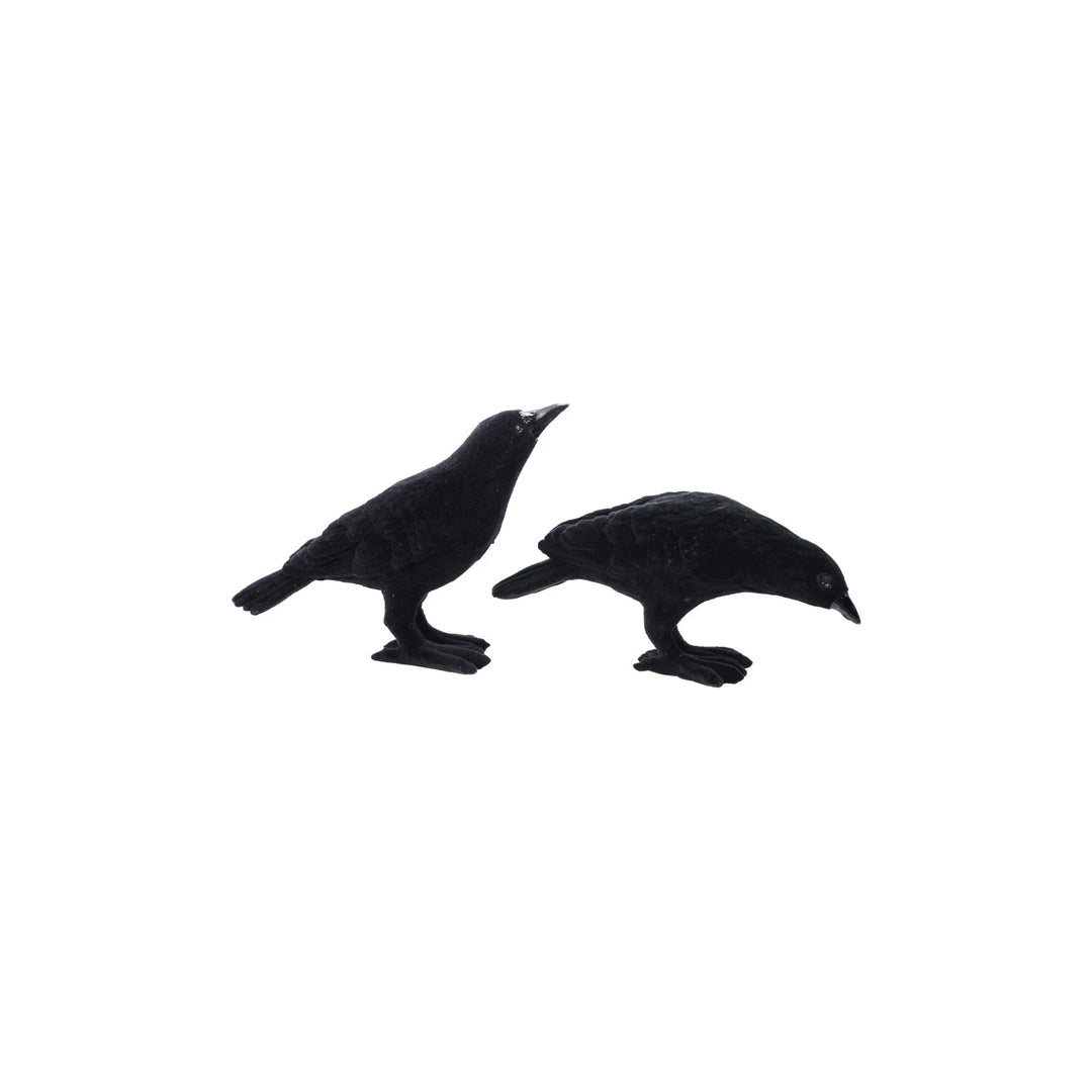 Two black bird figurines on a white background