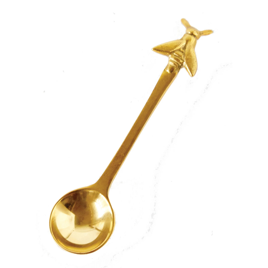 Gold spoon with a starfish handle on a white background