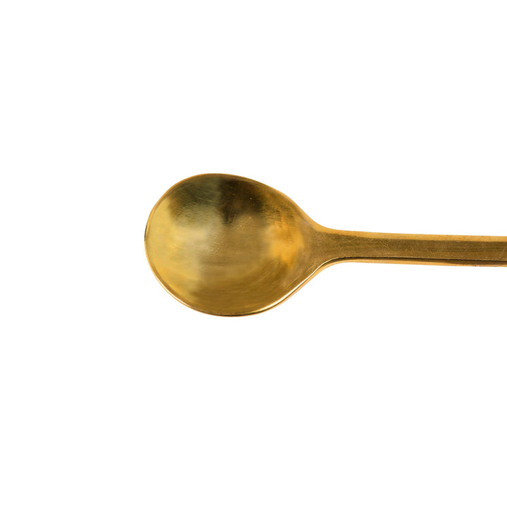 Gold spoon on a white background
