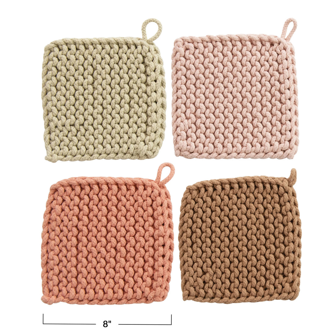 Four knitted pot holders in beige, pink, and brown on a white background.