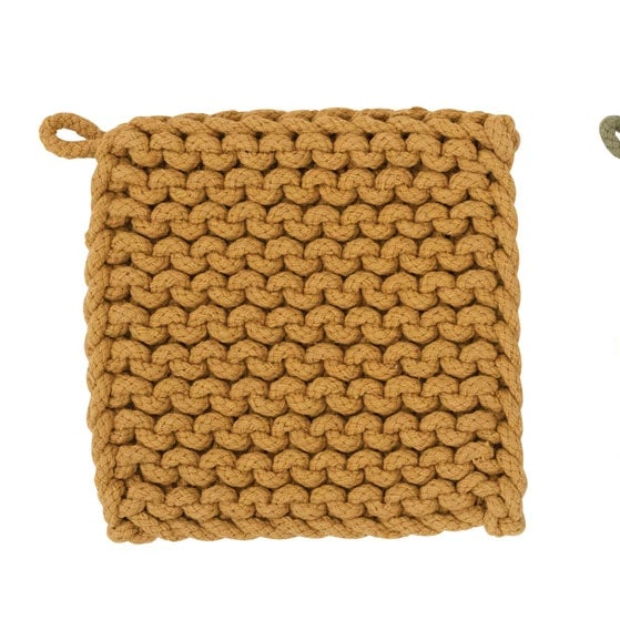 Three knitted pot holders in mustard, green, and beige on a white background