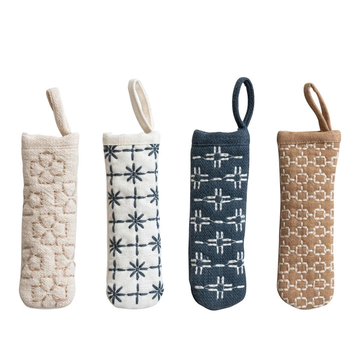 Four textured fabric bags with different patterns on a white background