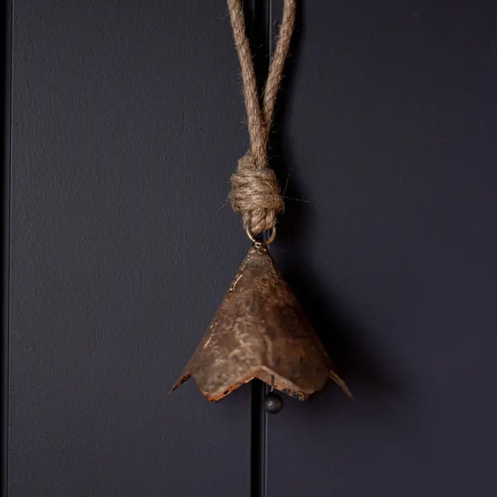 Full view of vintage-style bronze iron bell ornament with scalloped edges and thick hanging loop.