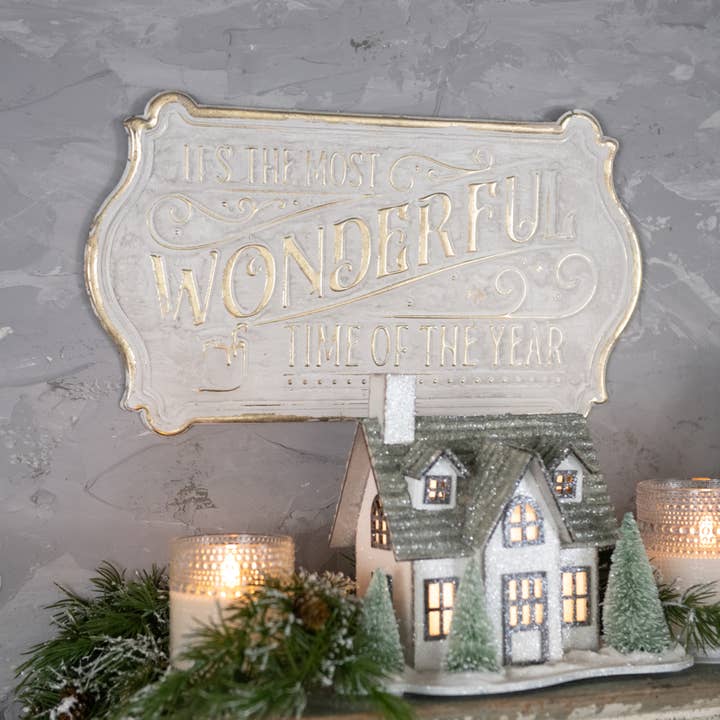White and gold shaped Christmas sign reading It’s the Most Wonderful Time of the Year