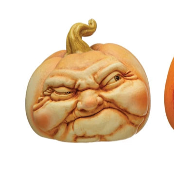 Three carved pumpkins with facial expressions on a white background
