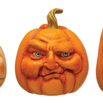 Three carved pumpkins with facial expressions on a white background