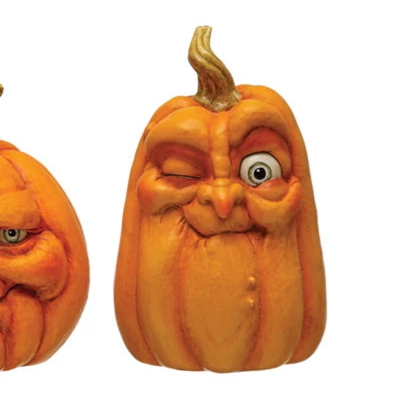 Three carved pumpkins with facial expressions on a white background