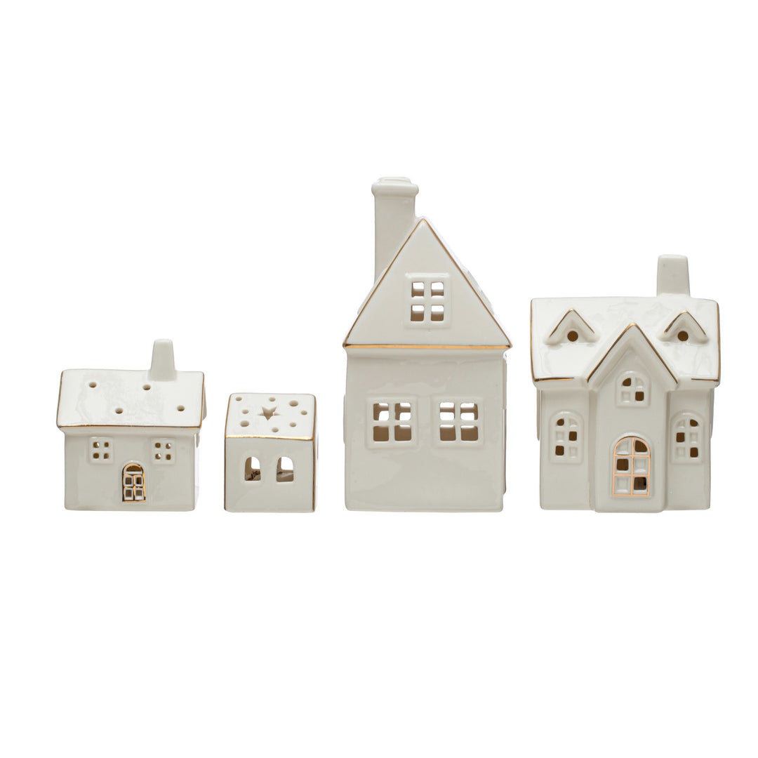 Set of four ceramic house-shaped tealight holders on a white background