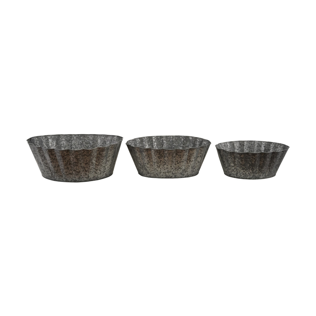 Three galvanized metal planters of different sizes on a white background